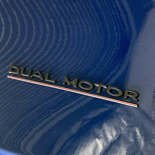 Performance Dual Motor emblem in different colors